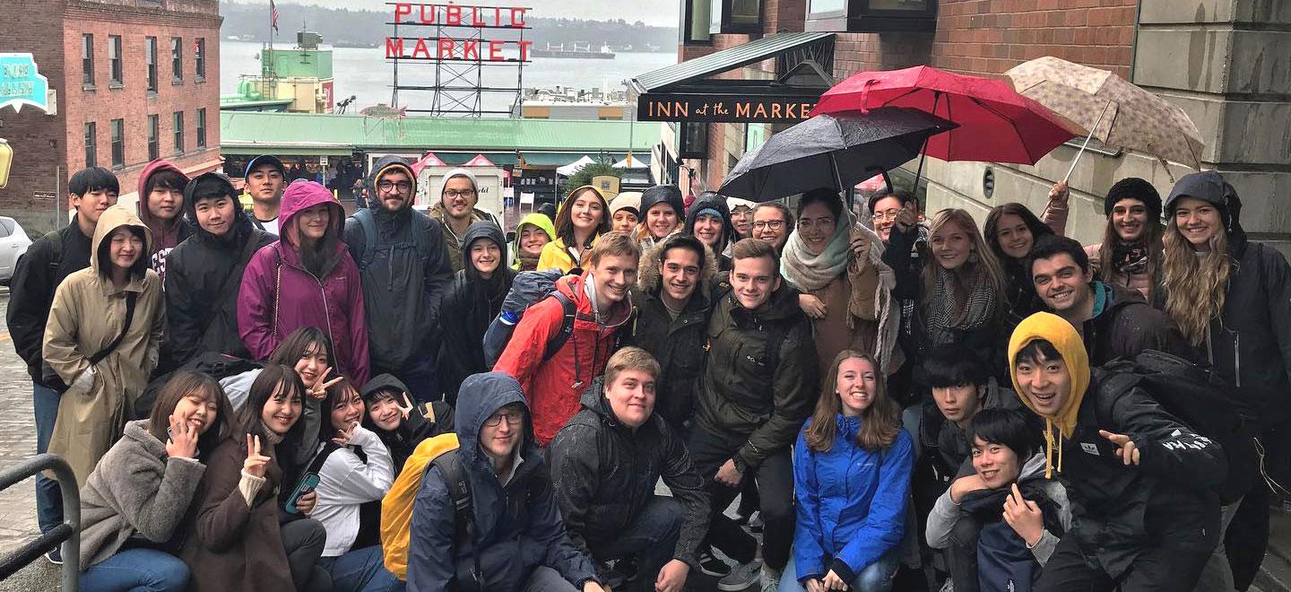 A group of international students stand outside Pike Place Market in Seattle